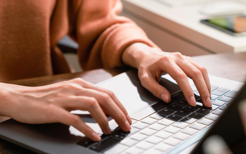 Woman typing on a laptop